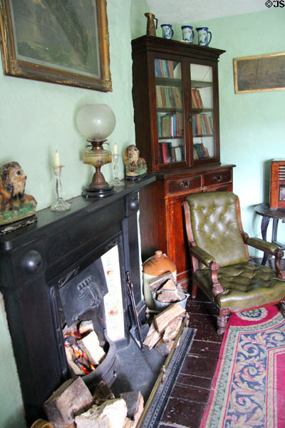 Sitting area with fireplace & glassed in book shelves at Quille's farm at Muckross Traditional Farms in Killarney National Park. Killarney, Ireland.