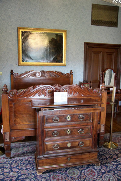 Blue bedroom with chest of drawers & carved bed at Kilkenny Castle. Ireland.