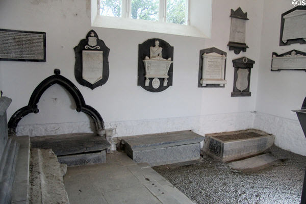 Post-Protestant Reformation (later 1500s) burial monuments on wall over older Catholic tombs well-preserved below line to where floor was raised (mid 1700s) at Medieval Mile Museum. Kilkenny, Ireland.