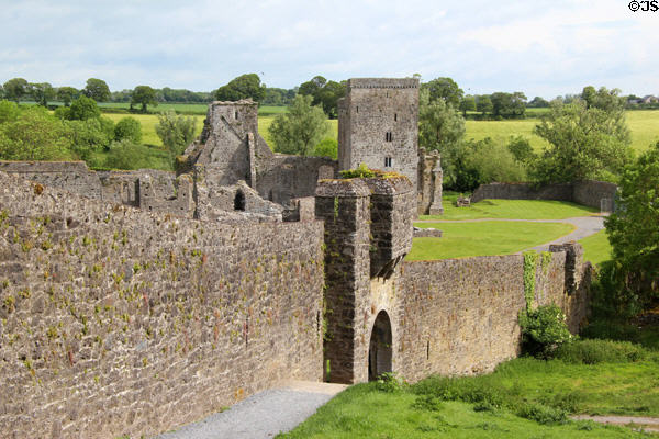 Walls at Kells Priory with church beyond. Ireland.