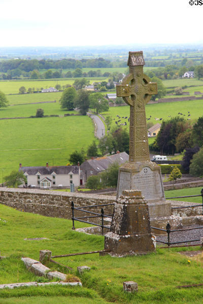 Celtic cross over town & country at Rock of Cashel. Cashel, Ireland.