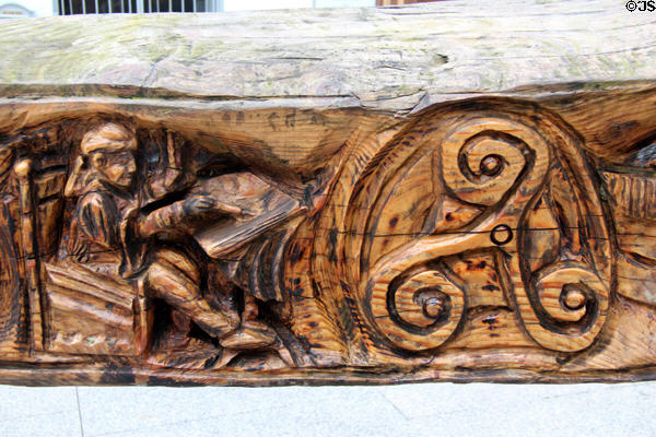 Irish monk recording peace with Vikings (902-914) detail of Viking sword sculpture by John Hayes near Reginald's Tower. Waterford, Ireland.