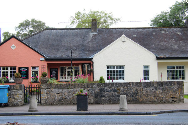 Pink building with slate roof (1936). Adare, Ireland.