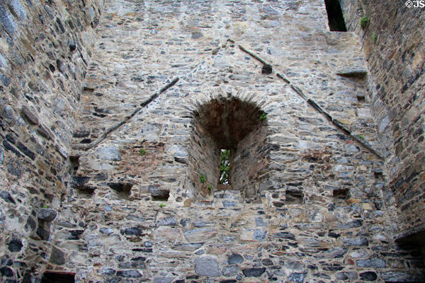 Interior wall with deeply inset window & old roof line at Desmond Castle. Adare, Ireland.