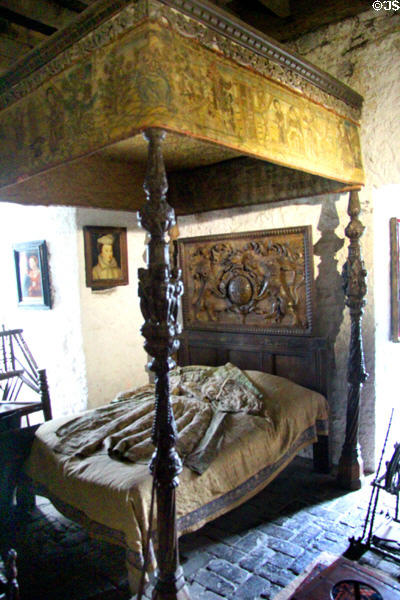 Carved wooden bedstead with tapestry canopy in Earl's bedroom at Bunratty Castle. County Clare, Ireland.
