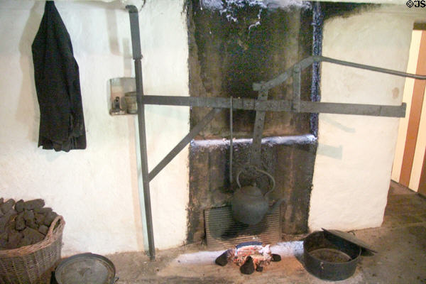 Basket with peat near cooking fire in Mountain Farmhouse at Bunratty Castle & Folk Park. County Clare, Ireland.