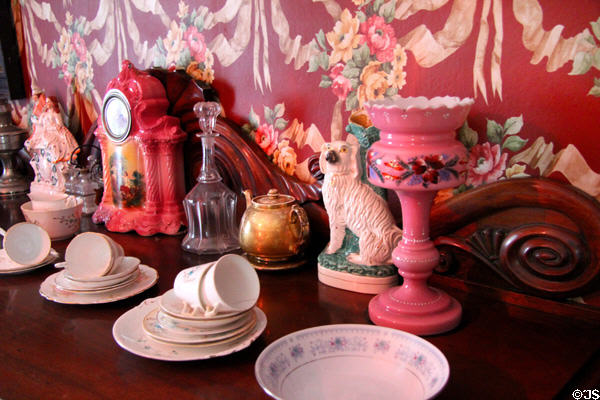 Brightly patterned wallpaper & decorative items on sideboard in Golden Vale Farmhouse at Bunratty Castle & Folk Park. County Clare, Ireland.