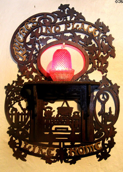 Ornately carved "There's No Place Like Home" candle stand in Golden Vale Farmhouse at Bunratty Castle & Folk Park. County Clare, Ireland.