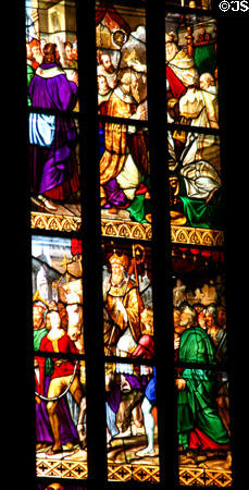 Story of saints in stained-glass of Duomo. Milan, Italy.