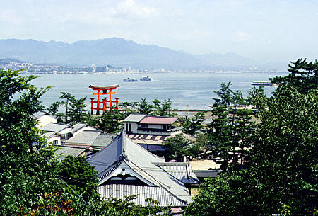 Red Torii, entrance gate to a Shinto shrine, as seen from a hill in Miya-jima. Japan.