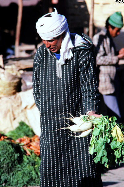 Vendor of root vegetables in souk. Erfoud, Morocco.