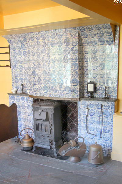 Delft tile fireplace surround inset with coal stove at Arnhem Openlucht Museum. Arnhem, Netherlands.