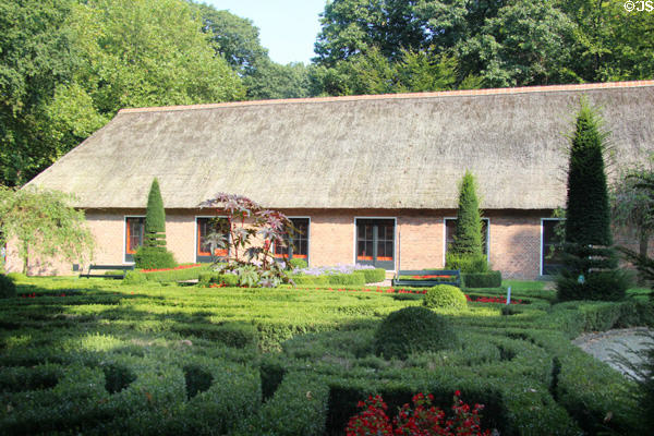 Thatched roof building with formal garden at Arnhem Openlucht Museum. Arnhem, Netherlands.