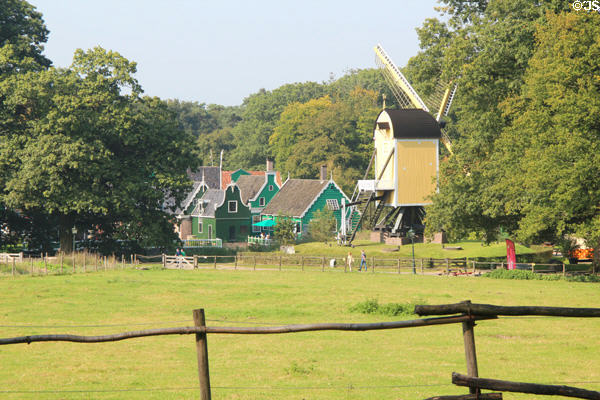 Village buildings & post-mill viewed from a distance at Arnhem Openlucht Museum. Arnhem, Netherlands.