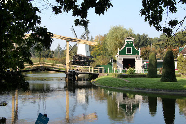 Village view with windmill, mill pond & lifting footbridge at Arnhem Openlucht Museum. Arnhem, Netherlands.