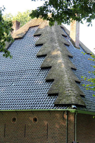 Building with metal roof with design created with thatching at Arnhem Openlucht Museum. Arnhem, Netherlands.