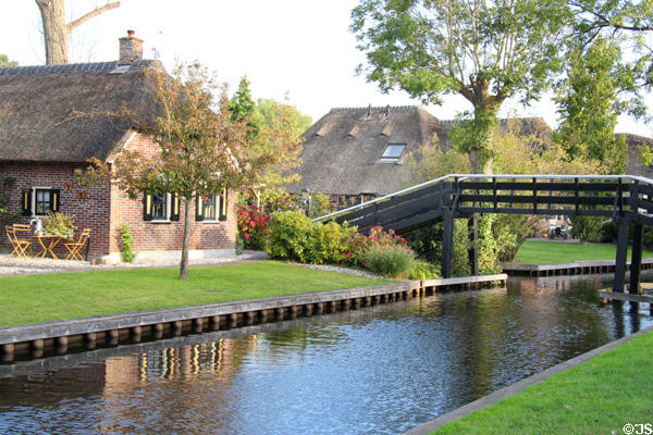 Typical view of thatched roof homes lining canal. Giethoorn, Netherlands.