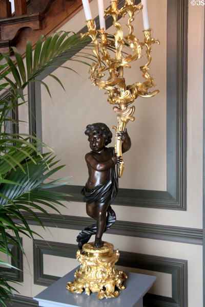 Statue holding gilded candelabra in stairwell. Het Loo, Netherlands.