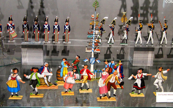 Tin figure array with soldiers & folk figures around Maypole at National Tin Figure Museum. Ommen, Netherlands.