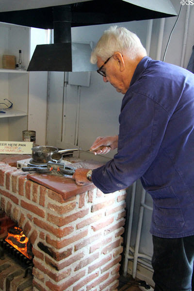 Pan heated to dangerously high temperature to melt down tin at National Tin Figure Museum. Ommen, Netherlands.