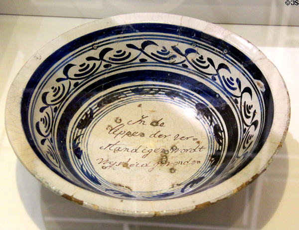 Stoneware bowl with Dutch script in the center at ANNO Stadsmuseum Zwolle. Zwolle, Netherlands.