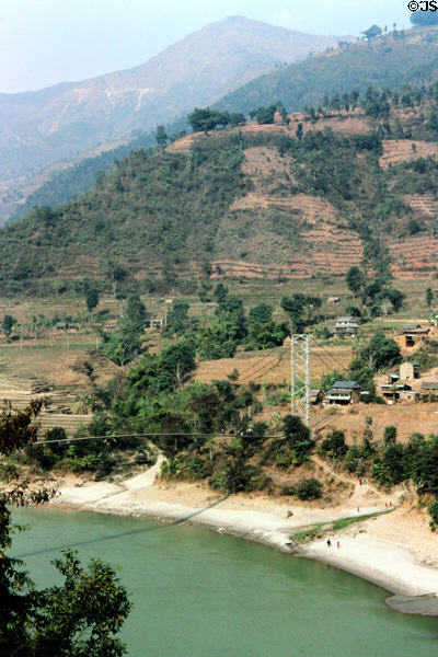 Suspension bridge across mountain river seen from road to Katmandu. Nepal.