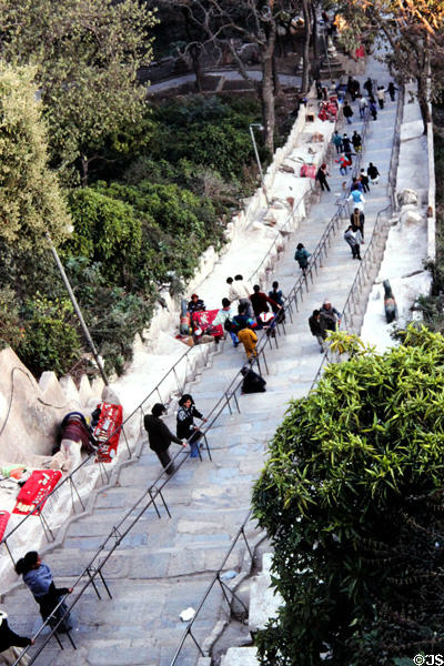 Worshippers climb steps to Swayambhunath Buddhist Temple in Katmandu. Nepal.