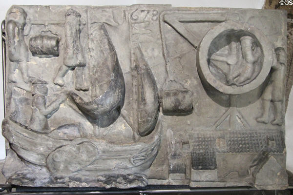 Stingmen of Leith stone panel (1678) showing men who carried imported wine barrels on poles at Museum of Edinburgh. Edinburgh, Scotland.