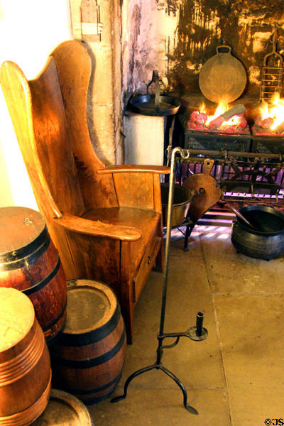 Armchair & adjustable candle stick in kitchen at Gladstone's Land tenement house. Edinburgh, Scotland.