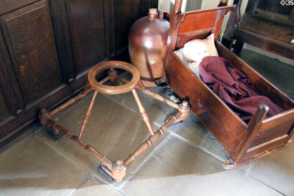 Child walking frame & cradle at Gladstone's Land tenement house. Edinburgh, Scotland.