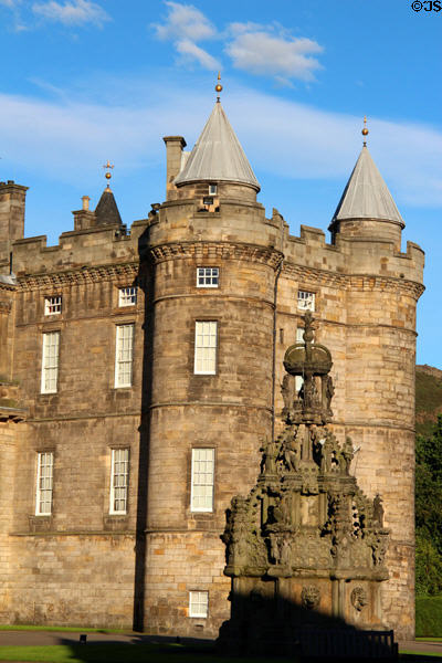 Fountain against towers of Holyrood Palace. Edinburgh, Scotland.
