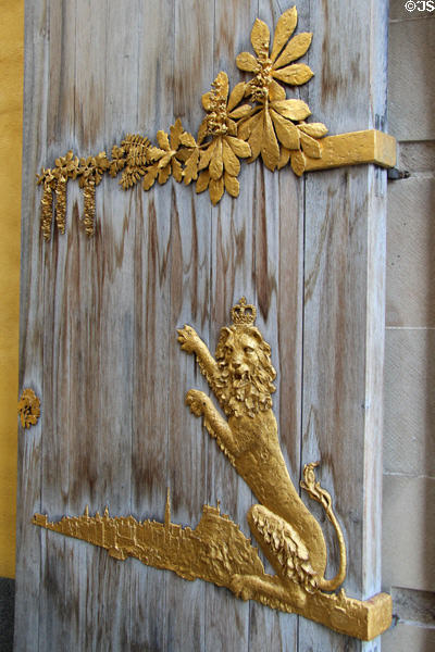 Royal lion under spray of leaves on entrance doors at Queens Gallery. Edinburgh, Scotland.
