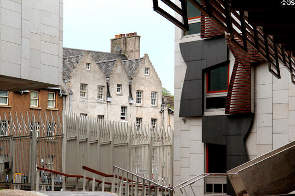 Modern architecture of Scottish Parliament embraces antique stone buildings of Royal Mile. Edinburgh, Scotland.