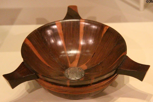 Wooden quaich with three handles with silver coin of Charles II at National Museum of Scotland. Edinburgh, Scotland.