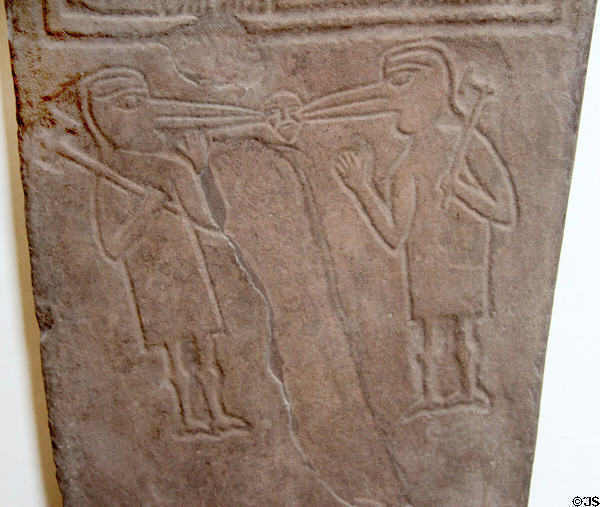 Symbolic Pictish bird-headed men pecking a human head (700-900) on Papil cross at National Museum of Scotland. Edinburgh, Scotland.