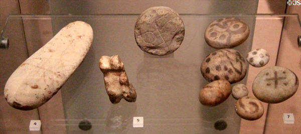 Stone amulets or gaming pieces with Pictish symbols (400-800) mostly from Burrian at National Museum of Scotland. Edinburgh, Scotland.