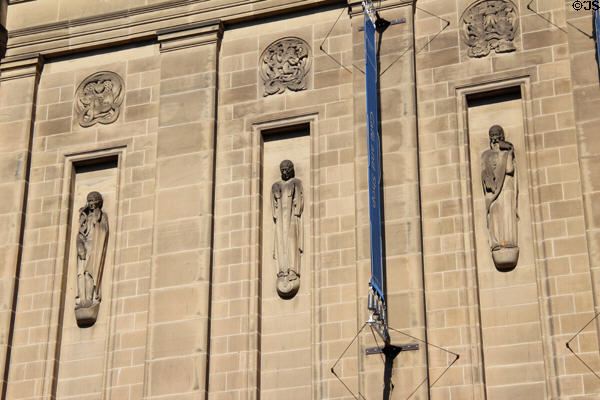 Sculpted figures by Hew Lorimer under rondels by E. Dempster on facade of National Library of Scotland. Edinburgh, Scotland.