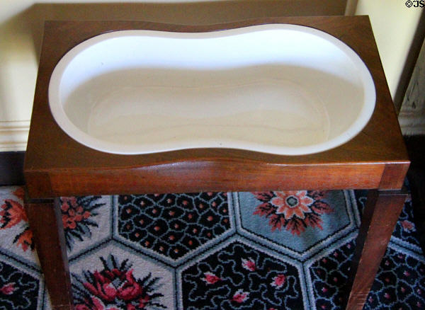 Bidet on wooden stand in bedchamber at Georgian House museum. Edinburgh, Scotland.
