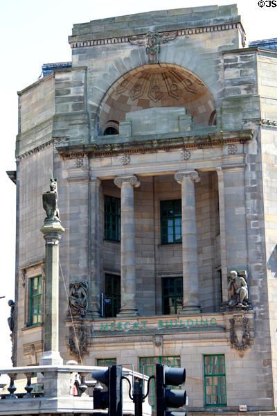 Mercat Cross (1930) by Edith Burnet Hughes before Mercat Building (1928-33) (High St. at London Rd.). Glasgow, Scotland. Architect: A. Graham Henderson.