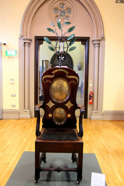 Oak chair with Black Stone dolerite slab upon which University of Glasgow students sat for oral exams as far back as 1451 at Hunterian Museum. Glasgow, Scotland.