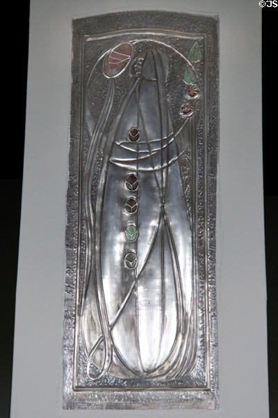 Metal plaque in style of Margaret Macdonald on hall pillar at House for an Art Lover. Glasgow, Scotland.