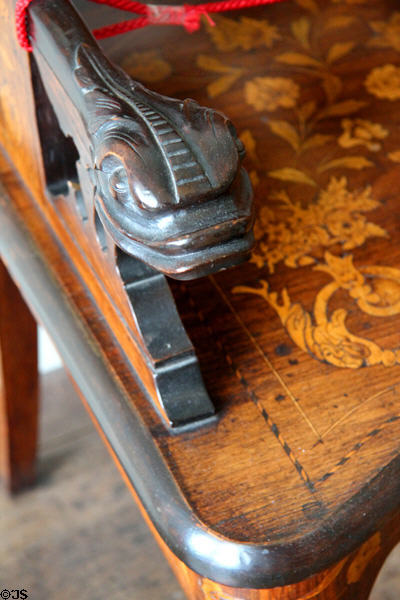 Carved dragon handle on inlaid armchair at Pollok House. Glasgow, Scotland.