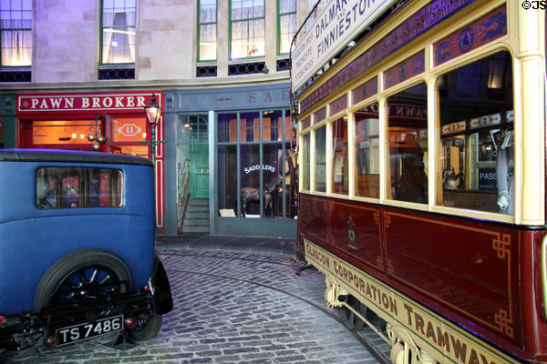 Glasgow tram & auto on replica historical streetscape at Riverside Museum. Glasgow, Scotland.