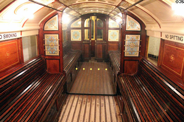Model of circular interior of Glasgow & District Subway car from 1896 with seats along side to allow people to walk down middle at Riverside Museum. Glasgow, Scotland.