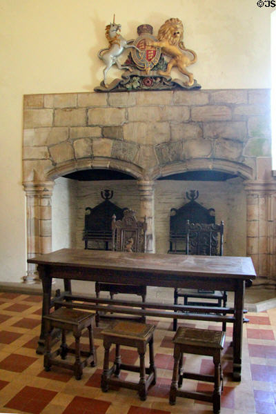 Lord's Hall fireplace & table with stools at Doune Castle. Doune, Scotland.