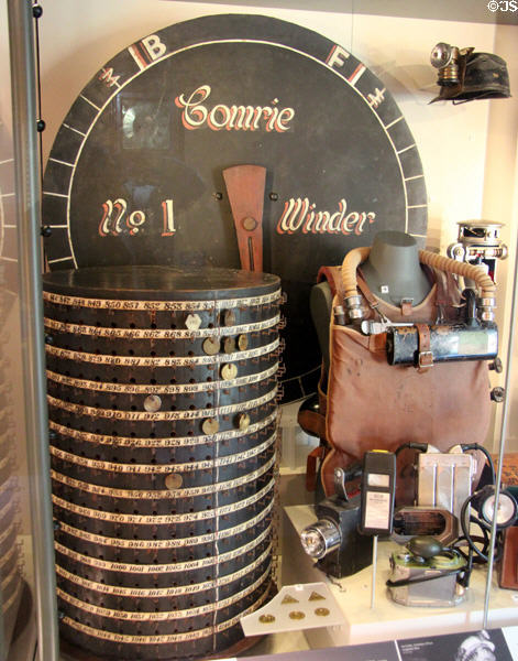 Miner's Tally Drum used to keep track of who was down in mine under indicator which told engineman when lift cage reached bottom of mine shaft plus other mining artifacts at Dunfermline Carnegie Library Museum. Dunfermline, Scotland.