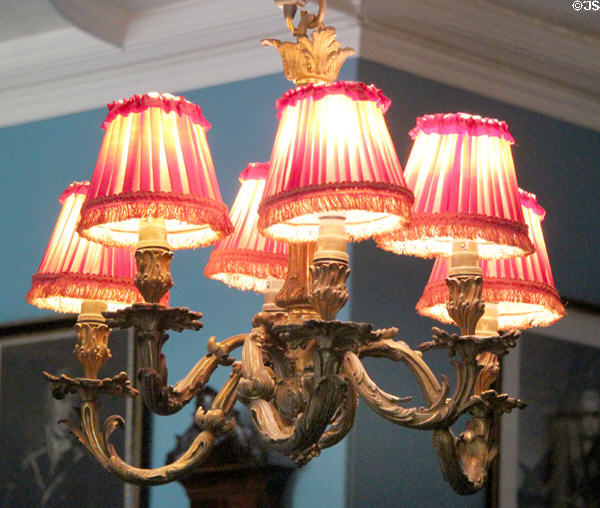 Highly decorative chandelier with fringed lamp shades in Oak Room at Lauriston Castle. Edinburgh, Scotland.