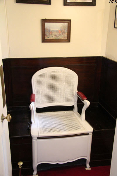 Commode chair in bathroom with flush pull on floor at Lauriston Castle. Edinburgh, Scotland.