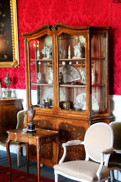 Glass display cabinet with marquetry on front wooden panels in withdrawing room at Lauriston Castle. Edinburgh, Scotland.
