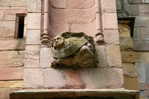 Bearded wall sculpture with scroll at Melrose Abbey. Melrose, Scotland.